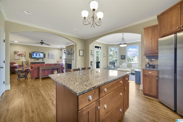 2399 Huntington Glen Dr, Homewood, AL 35226 - kitchen featuring freestanding refrigerator, open floor plan, arched walkways, light wood finished floors, and recessed lighting