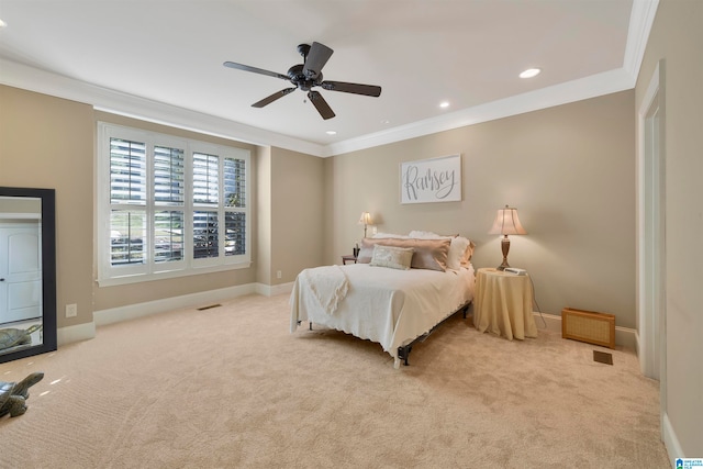 bedroom with ceiling fan, ornamental molding, and light carpet