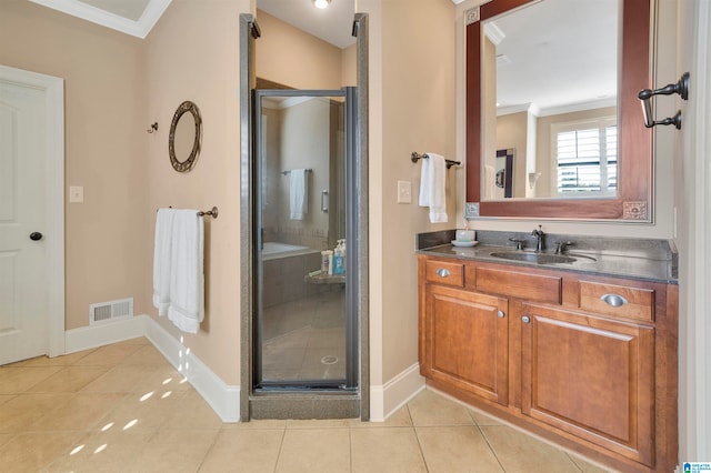 bathroom with tile patterned flooring, vanity, a shower with door, and crown molding