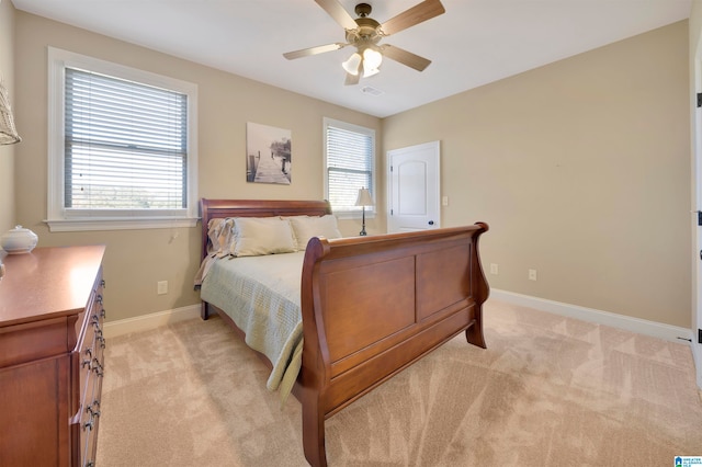 bedroom with ceiling fan and light carpet