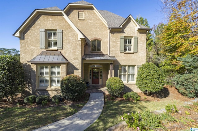 2399 Huntington Glen Dr, Homewood, AL 35226 - view of front facade with a standing seam roof, stucco siding, a shingled roof, and a front lawn