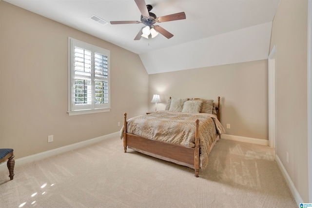 carpeted bedroom featuring ceiling fan and vaulted ceiling