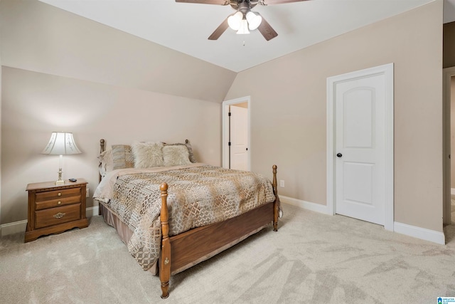 bedroom with ceiling fan, light colored carpet, and lofted ceiling