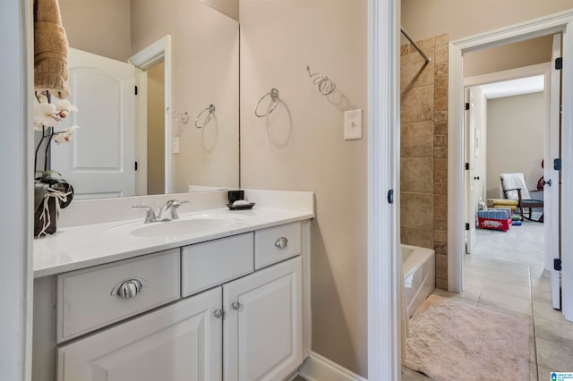 bathroom featuring tile patterned flooring, vanity, and tiled shower / bath combo