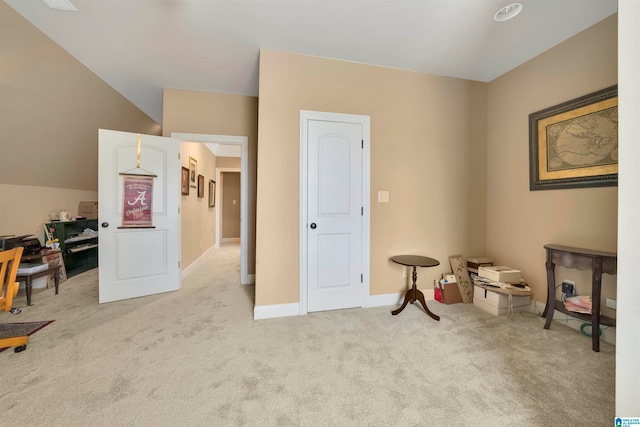 interior space with light colored carpet and lofted ceiling