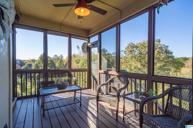 sunroom / solarium featuring ceiling fan and plenty of natural light