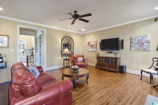 living room featuring ceiling fan, light hardwood / wood-style floors, and ornamental molding