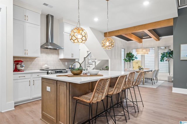 4178 Arnold Ln, Hoover, AL 35244 - kitchen with wall chimney range hood, decorative backsplash, beam ceiling, light wood-type flooring, and white cabinetry