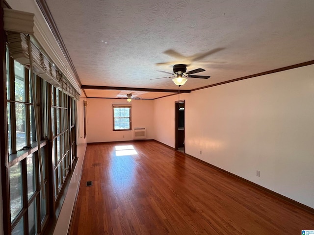 spare room featuring an AC wall unit, crown molding, dark hardwood / wood-style floors, ceiling fan, and a textured ceiling