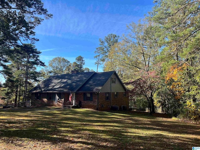 view of front of home with a front yard and central AC unit