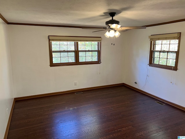 empty room featuring a textured ceiling, dark hardwood / wood-style flooring, plenty of natural light, and ceiling fan