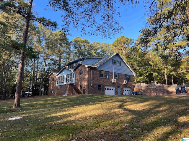 back of house with a yard and a garage