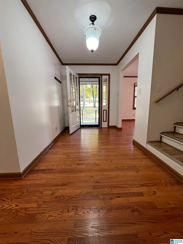 foyer entrance with hardwood / wood-style floors and ornamental molding