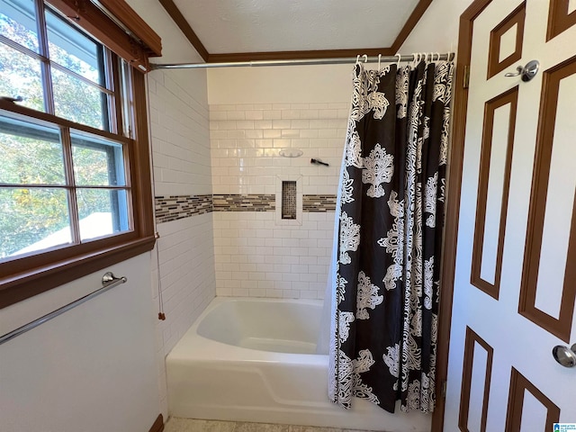 bathroom with shower / tub combo and a textured ceiling