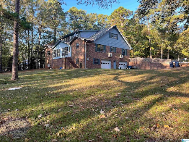 view of side of property with a lawn and a garage