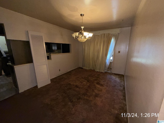 unfurnished dining area with dark carpet and an inviting chandelier