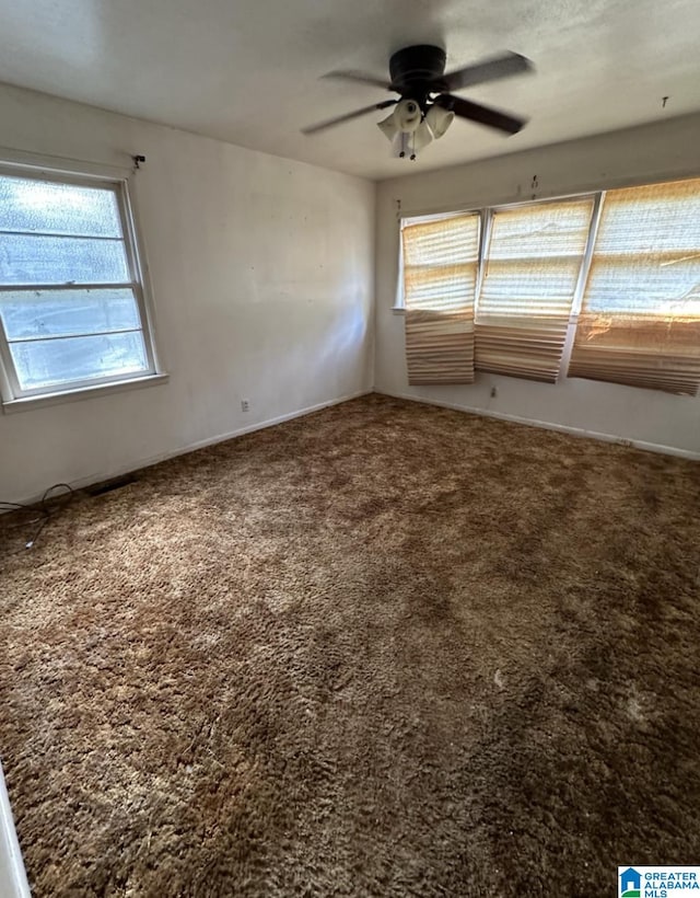 carpeted empty room featuring ceiling fan