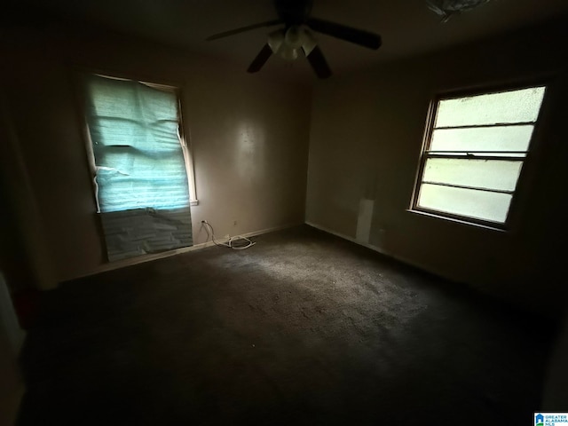 carpeted spare room featuring ceiling fan