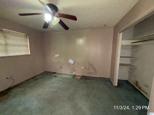 unfurnished bedroom with dark colored carpet, a closet, and ceiling fan