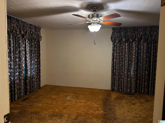 unfurnished room with carpet floors and ceiling fan