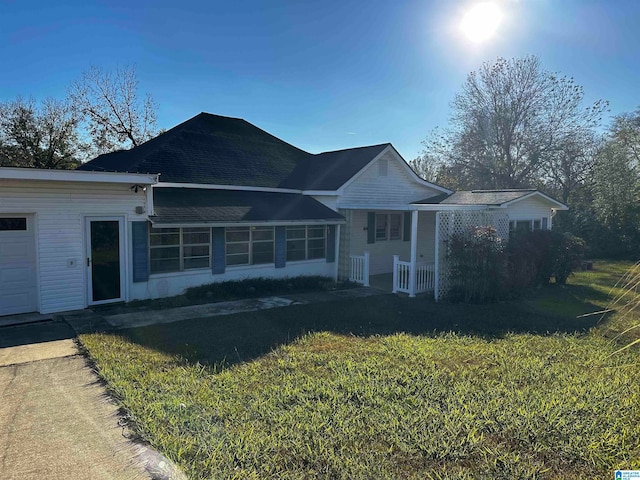 view of front of home with a front yard and a garage