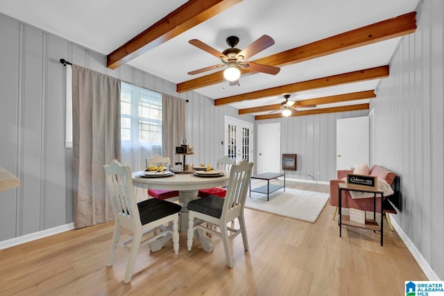 dining area featuring ceiling fan, beamed ceiling, and light hardwood / wood-style floors