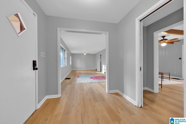 hallway with light hardwood / wood-style flooring