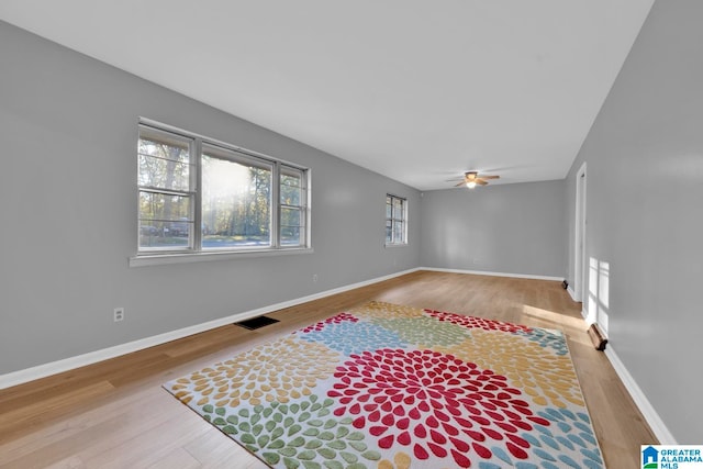 unfurnished room with ceiling fan and hardwood / wood-style floors