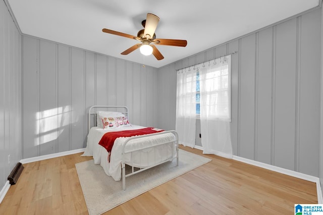 bedroom with light hardwood / wood-style floors and ceiling fan