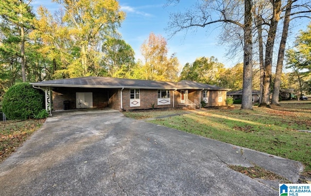 ranch-style house with a carport and a front lawn