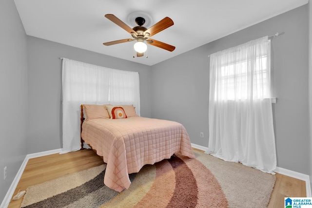 bedroom with hardwood / wood-style flooring and ceiling fan