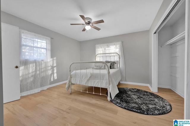 bedroom featuring wood-type flooring, a closet, and ceiling fan