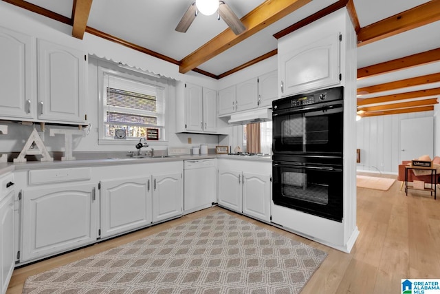 kitchen with a wealth of natural light, black double oven, beam ceiling, dishwasher, and white cabinets