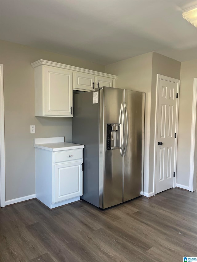 kitchen featuring white cabinets, dark hardwood / wood-style floors, and stainless steel refrigerator with ice dispenser