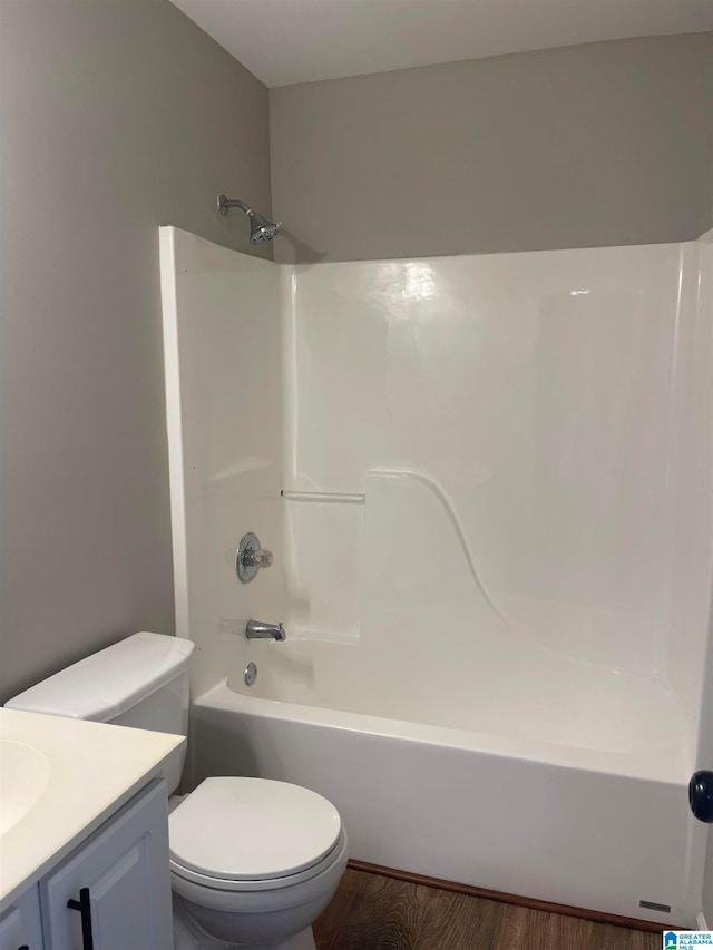 full bathroom featuring shower / bath combination, vanity, wood-type flooring, and toilet