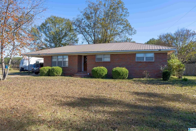 ranch-style home featuring a front yard and a carport