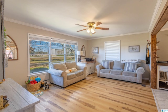 living room featuring ceiling fan, ornamental molding, and light hardwood / wood-style flooring