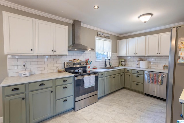 kitchen with sink, wall chimney exhaust hood, stainless steel appliances, and ornamental molding