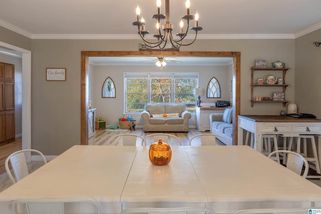 dining area with ceiling fan with notable chandelier, light hardwood / wood-style flooring, and crown molding