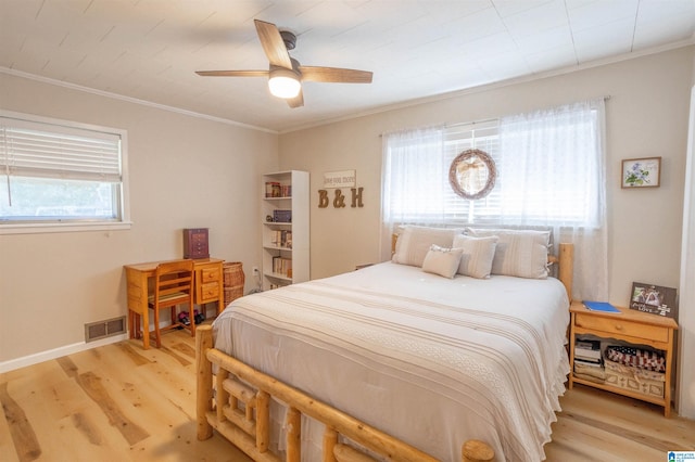 bedroom with ceiling fan, crown molding, and light hardwood / wood-style floors