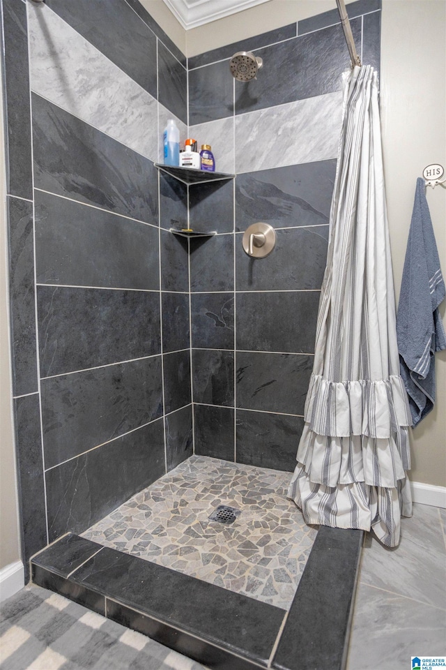 bathroom featuring curtained shower and ornamental molding