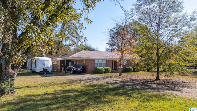 single story home with a front yard and a carport