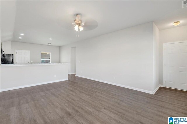 unfurnished living room with ceiling fan, dark wood-type flooring, and lofted ceiling