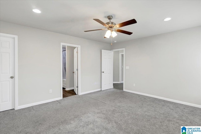 unfurnished bedroom with ensuite bath, ceiling fan, and carpet floors