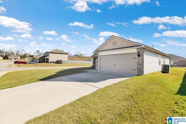 view of side of home featuring central AC, a yard, and a garage