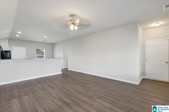 unfurnished living room with dark hardwood / wood-style floors, ceiling fan, and vaulted ceiling