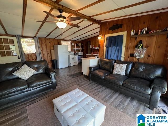 living room with wood walls, dark wood-type flooring, ceiling fan, and lofted ceiling with beams