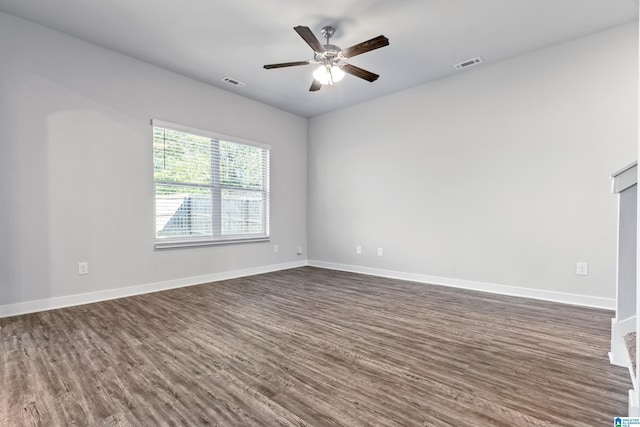 empty room with dark hardwood / wood-style flooring and ceiling fan