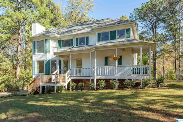 view of front facade featuring covered porch and a front lawn