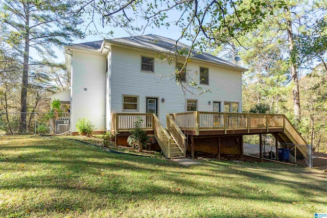 rear view of house with a yard and a wooden deck